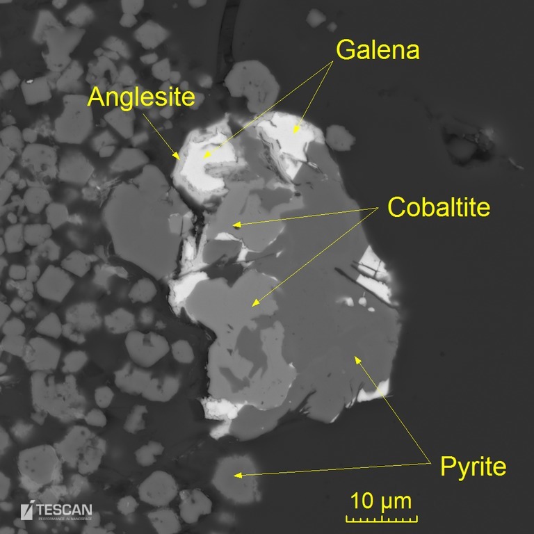 Partially weathered sulphide grain accompanied by euhedral pyrite